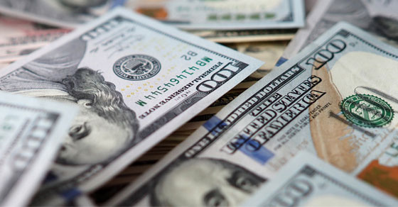 Piles of cash represented by $100 US bills